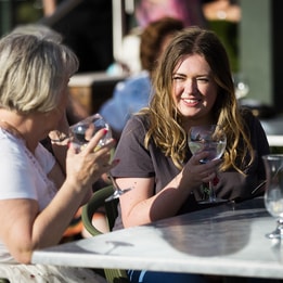 Guests enjoying gin and tonics on the Arden Terrace at Studley Castle