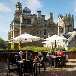 Guests on the terrace at Thoresby Hall having drinks from the Coffee Nest in the summer sun