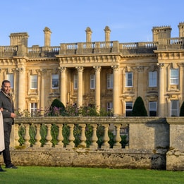 A couple walking in front of the main building at Heythrop Park during a winter escape
