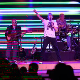 A vibrant band plays on stage at Studley Castle