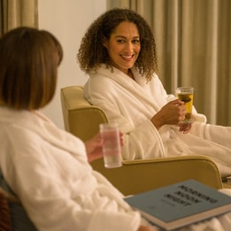 Two ladies relax in the relaxation room at Heythrop Park whilst they wait for their spa treatments