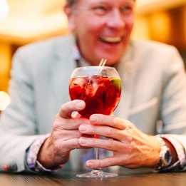 A guest laughing as he holds a cocktail