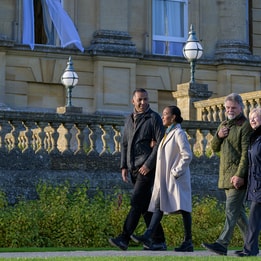 two couples walking with coats on, enjoying the gardens