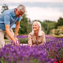 Couple admiring the flowers on the grounds of Cricket st. Thomas