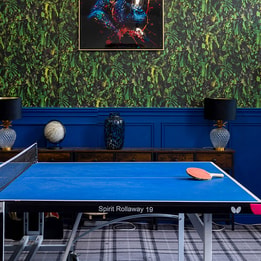 Hotel games room with table tennis, bold décor and contemporary leisure facilities.