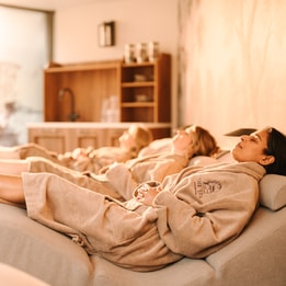 women in spa robes on spa beds