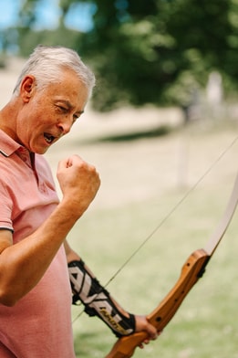 Man celebrating a hit in archery
