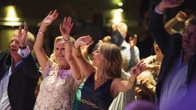 Guests dancing and smiling in the Atrium at Bodelwyddan Castle