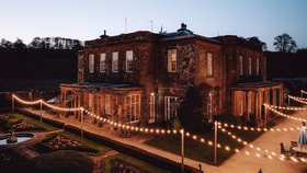 Cricket St Thomas in the evening, with fairy lights lit around the terrace