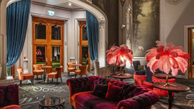 Elegant garden room at Studley Castle featuring a large, ornate ceiling and stylish furnishings.