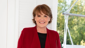 dana smiling in a red jacket