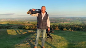 jules hudson holding camera equipment