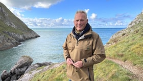 jules hudson standing next to ocean