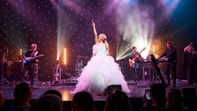 The Celine Experience performing in white dress