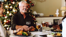 Guests toasting as they celebrate Christmas together at a Warner Hotel