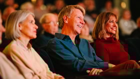 Guests watching a string quartet by candle light