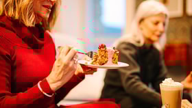 Close up of a guest enjoying a delicious festive treat from the Coffee Nest
