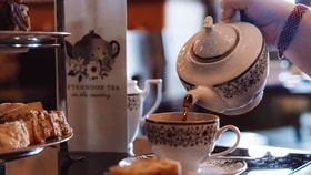 Close up of a guest pouring tea at afternoon tea