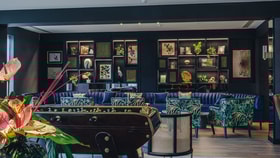 The Live Lounge showcases blue decor and furniture, creating a vibrant lounge space with table football at the Runnymede on Thames.