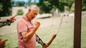 Man celebrating a hit in archery