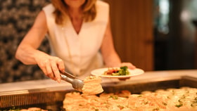 Guest choosing freshly prepared dishes from buffet
