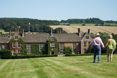 Two guests walking through the grounds of Littlecote House