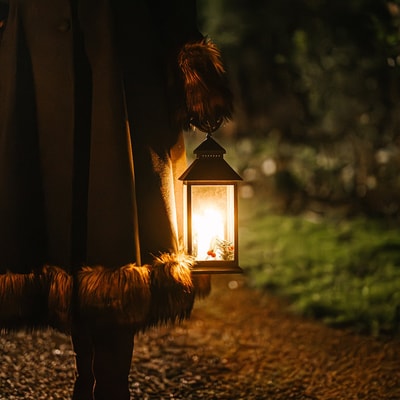 Guests wandering through the grounds on a lantern lit walk