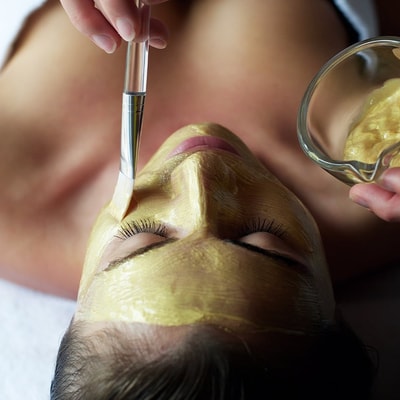 Person receiving a facial spa treatment
