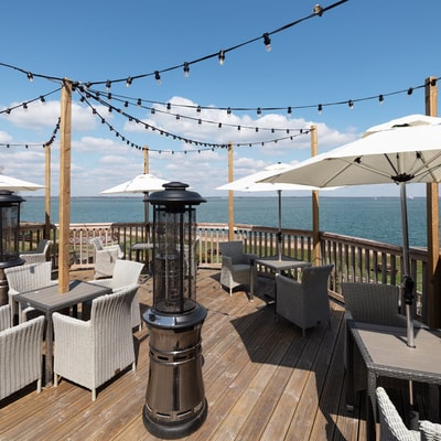 Wooden decking at Norton Grange overlooking the sea, with panoramic coastal views across the Isle of Wight.
