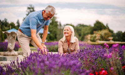 Couple admiring the flowers on the grounds of Cricket st. Thomas