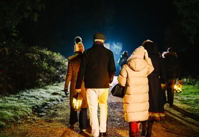 Guests wandering through the grounds on a lantern lit walk