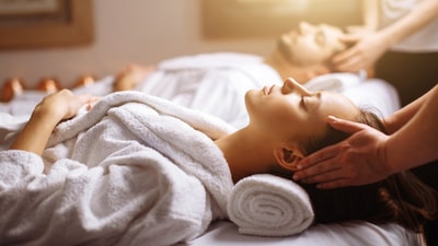 A woman relaxes while receiving a soothing massage in a tranquil spa setting.