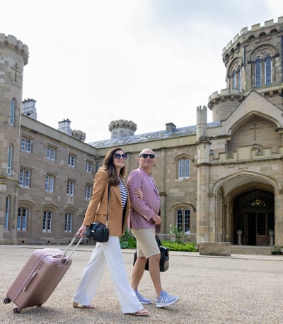 Couple with bags outside hotel
