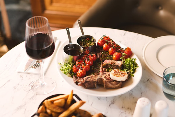 Savour your meal, perfectly complemented by a glass of wine.
