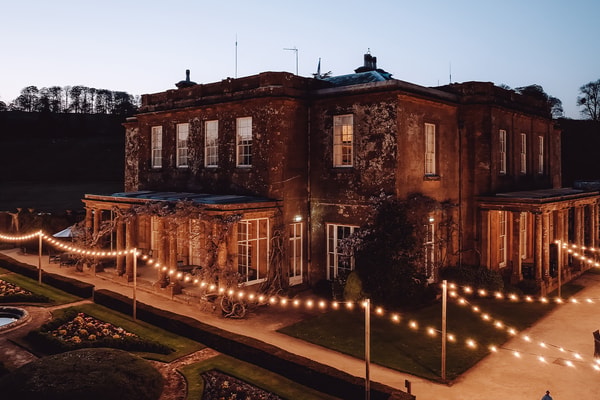 As evening falls, fairy lights twinkle across the terrace and gardens of Cricket House, casting a warm glow that feels nothing short of magical.