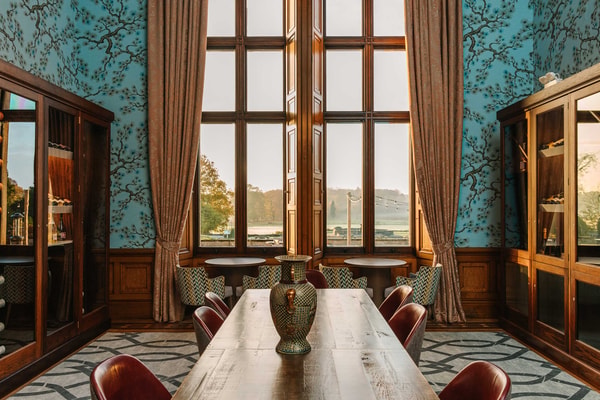 Through the windows of our historic Wine Room, the gardens stretch in quiet grandeur.