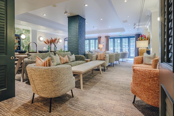 The inviting Garden Room lounge set beside The Spa is a welcoming space for well-being.