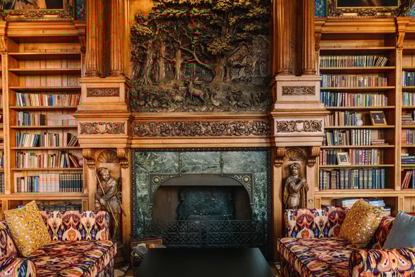 Lose yourself in the calm of this grand library, where walls of books invite quiet reflection.