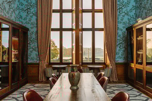 Through the windows of our historic Wine Room, the gardens stretch in quiet grandeur.