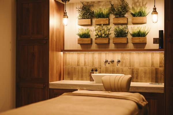 A serene spa treatment room, bathed in soft light, promising relaxation and rejuvenation.