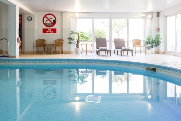 Relax in style at Corton with comfortable chairs and a serene indoor setting. Perfect for unwinding after a long day.