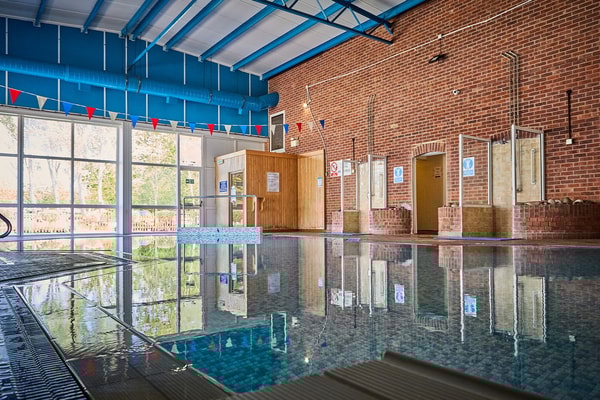 The charming brick walls and large windows surrounding Lakeside's indoor pool create a serene atmosphere, perfect for unwinding.