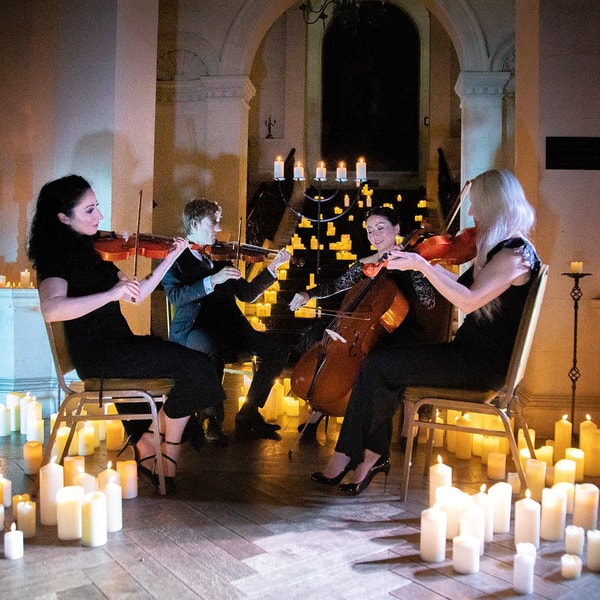 The glow of candlelight and the sound of festive melodies during a candlelit quartet performance create moments to remember (selected breaks).