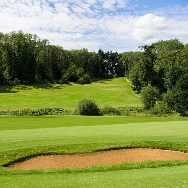 Where every swing comes with a Cotswold backdrop worth pausing for.