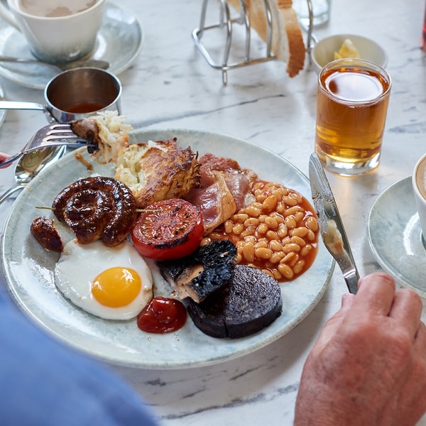 Brasserie32 breakfast - Cumberland ring, back bacon, baked beans, roasted tomato, Portobello mushroom, black pudding, potato and oat cake, served with fried egg.