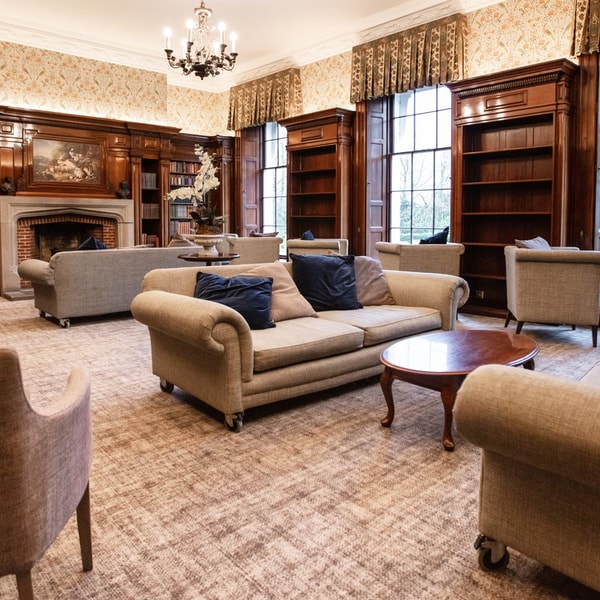 Step into the Library at Nidd Hall, where cosy seating and a tranquil atmosphere invite you to unwind with a book or simply relax.