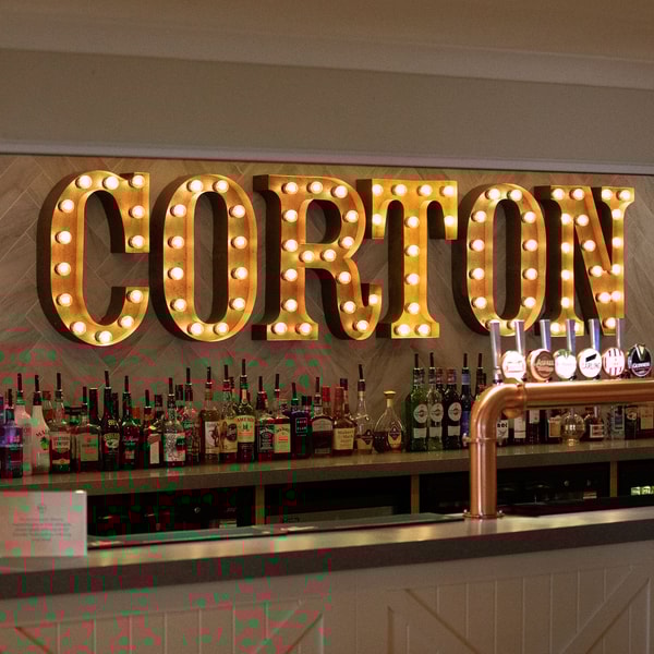 From classic cocktails to a selection of beers, wines and spirits, pick your favourite tipple, then relax, laugh, and enjoy time together under the warm glow of our iconic light-up sign.