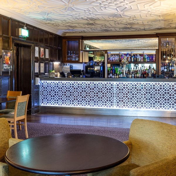 Step into our cosy bar, with glowing counters and stylish wooden details that add a whole lot of character.