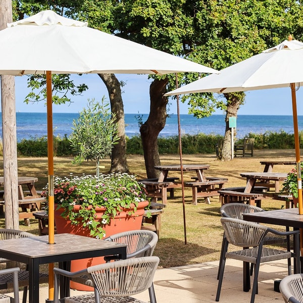 Relax on the terrace with a drink in hand, friends by your side, and the sparkling sea as your backdrop.