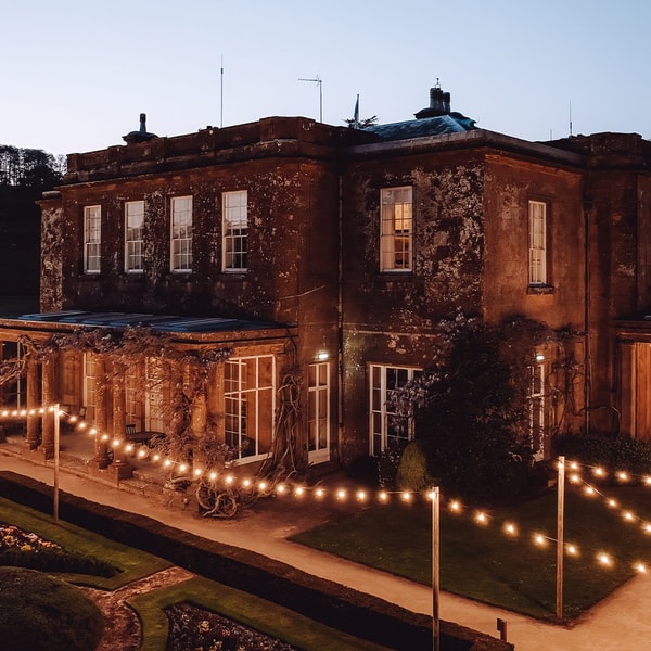 As evening falls, fairy lights twinkle across the terrace and gardens of Cricket House, casting a warm glow that feels nothing short of magical.